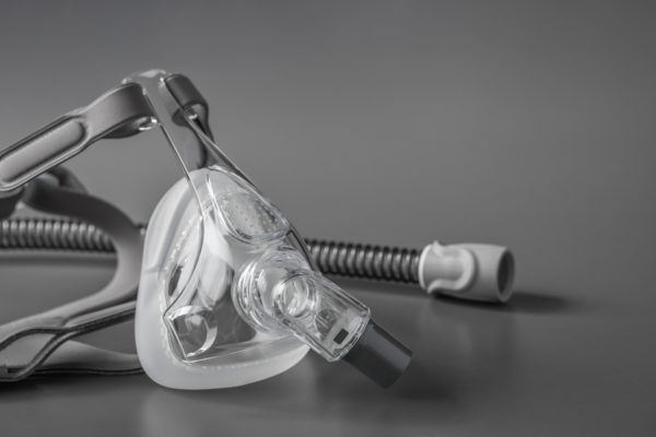 Sleep apnea CPAP mask on the grey background