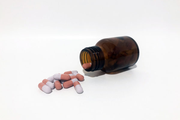 Medicine Pills or Tablets Drop and Out of the Brown Glass Bottle.