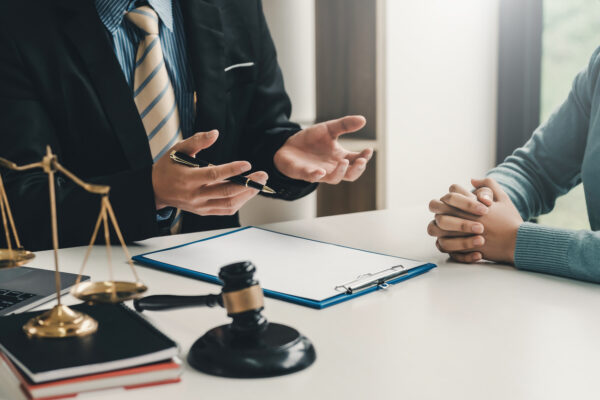 Image lawyer businessman sitting at the office with a woman customer explaining the agreement of advice.